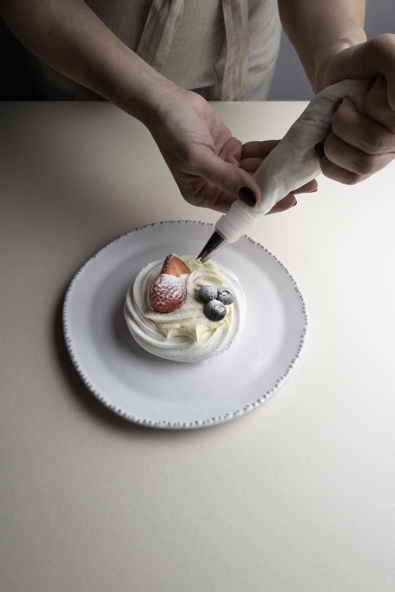 Chef arranging dessert on plate